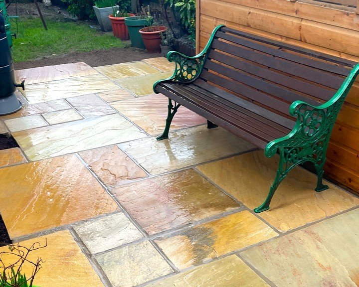 A garden design using natural sandstone paving slabs installed by Lyuven Garden maintenance team in Morden London.
