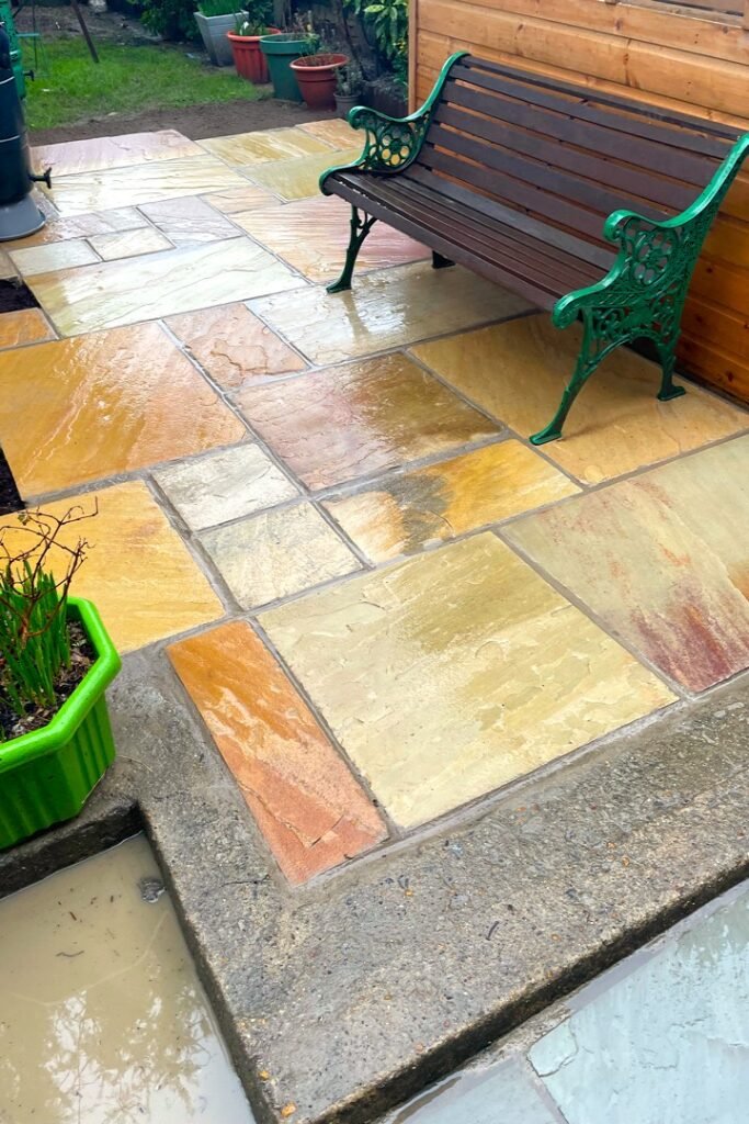 A garden design using natural sandstone paving slabs installed by Lyuven Garden maintenance team in Morden London.