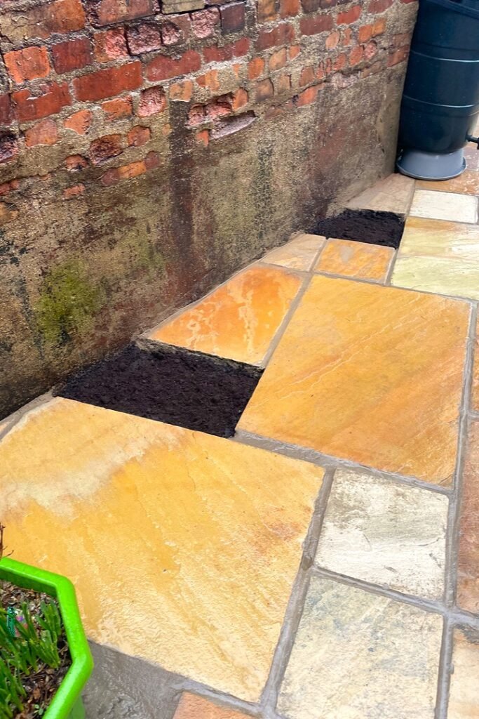 A garden design using natural sandstone paving slabs installed by Lyuven Garden maintenance team in Morden London.